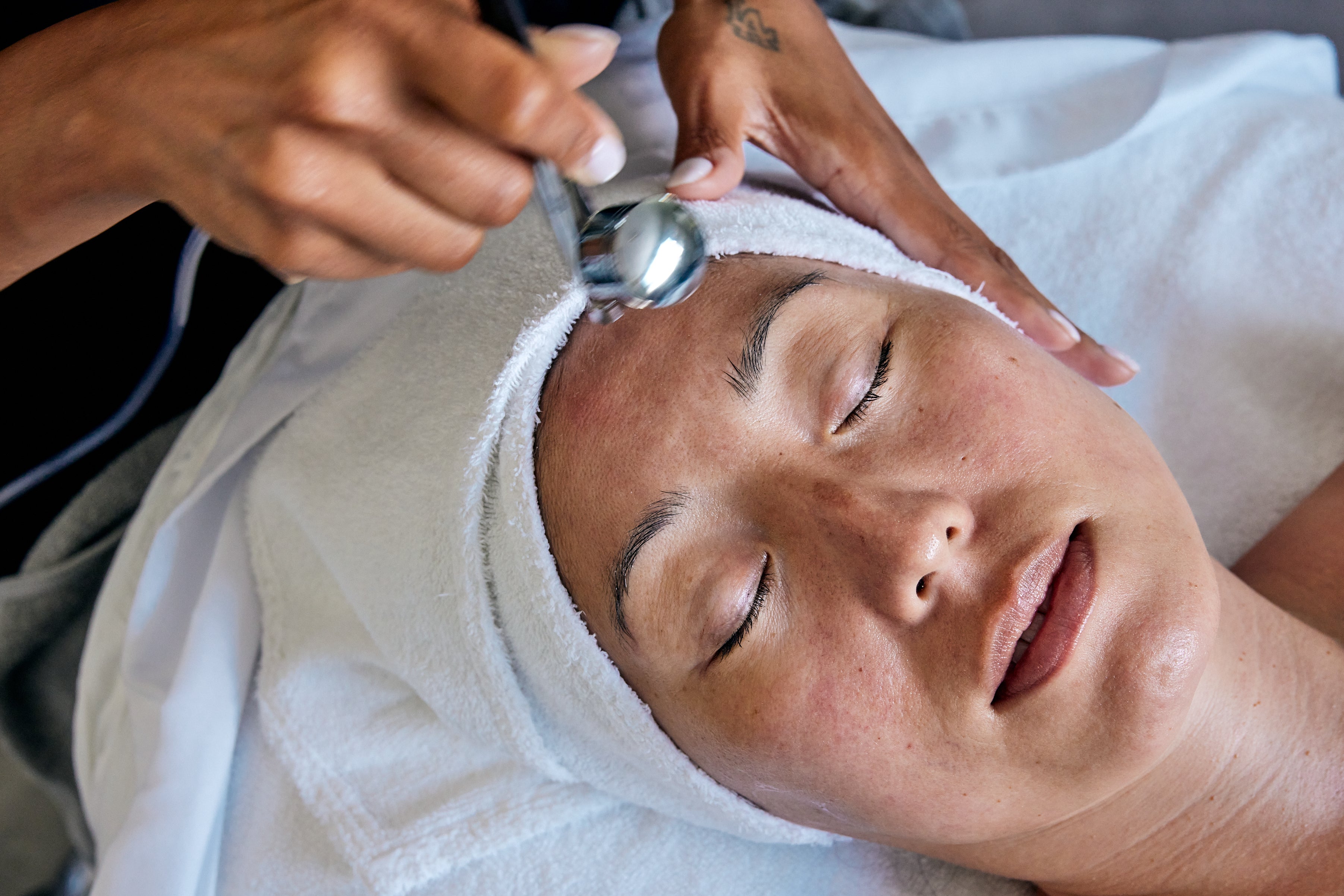 Client receiving LED light therapy after diamond-tip microdermabrasion at Joanna Vargas Spa West Hollywood.